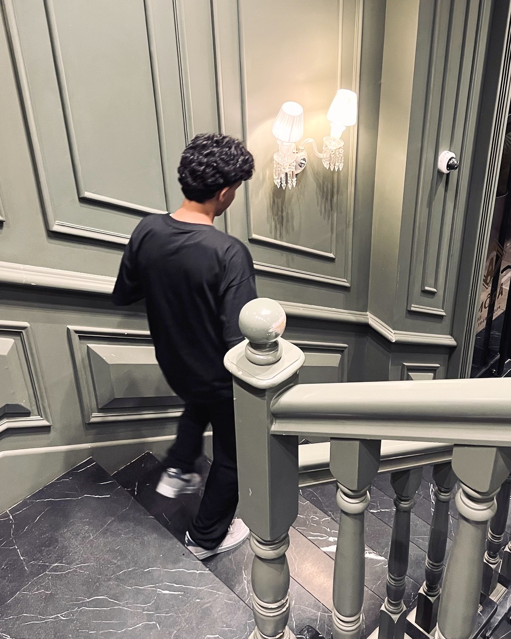 Alko, founder of Soowix, walking down a staircase